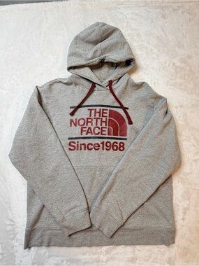 The North Face Gray Pullover Hoodie with Red Logo and Drawstrings